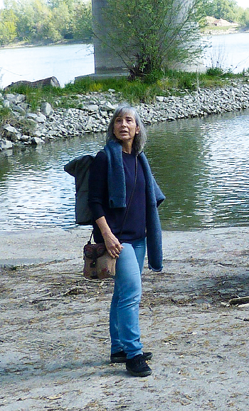 a person standing next to a body of water