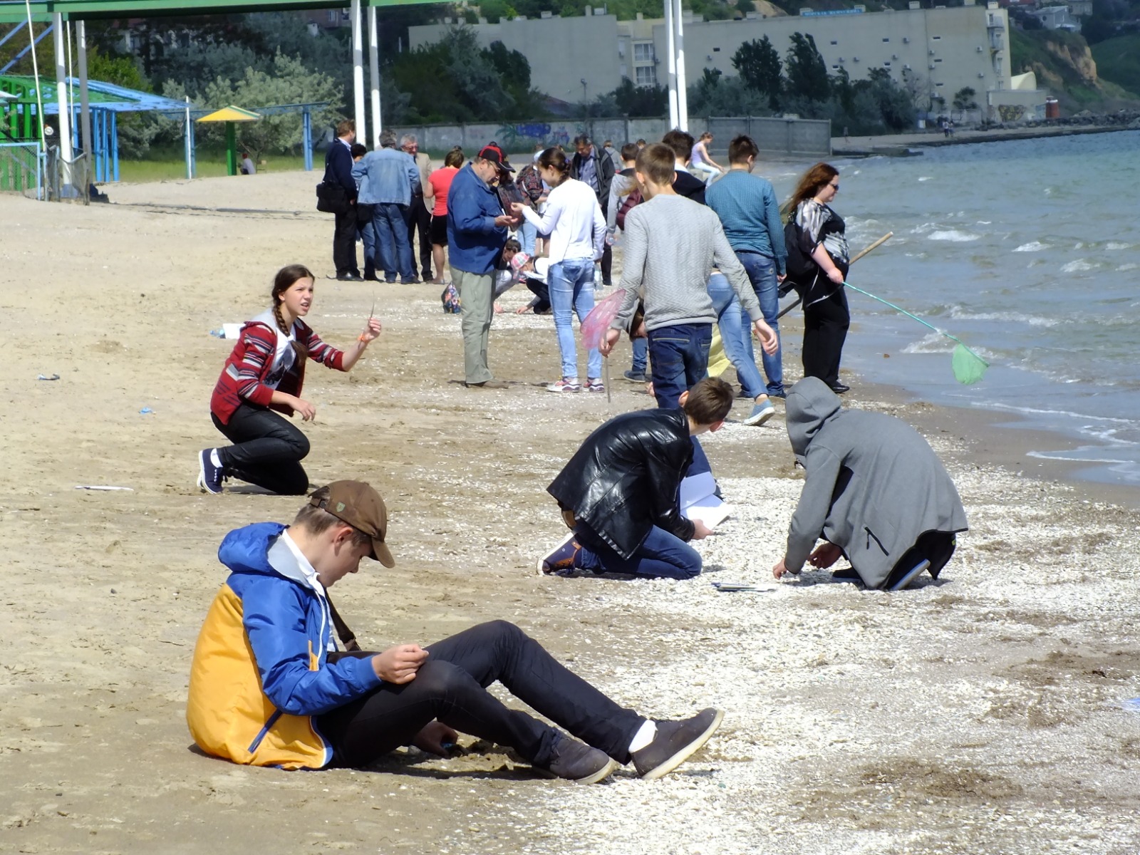a group of people sitting at a beach