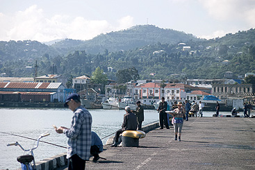 a group of people standing next to a body of water