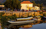 a small boat in a body of water with a city in the background