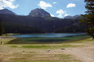 a body of water with a mountain in the background