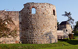 Credit: Kuttner a large brick building with grass in front of a house
