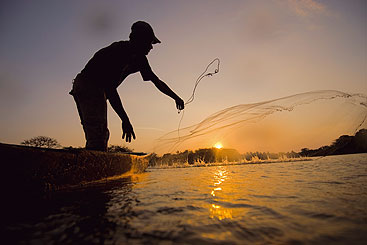 a man with a sunset in the background