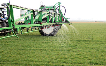 a large machine in a field of green grass