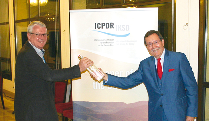 © ICPDR a man standing next to a woman holding a video game