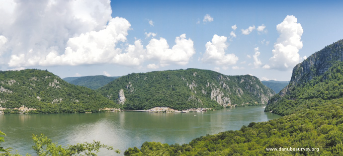 a body of water with a mountain in the background