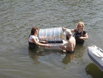 a group of people standing next to a body of water