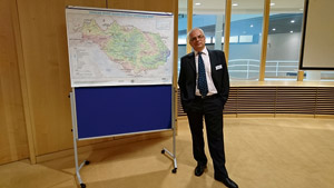 Zoran Major a person standing next to a map