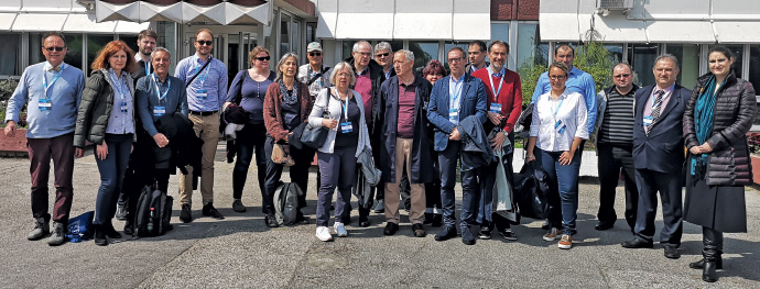 a group of people standing in front of a crowd posing for the camera