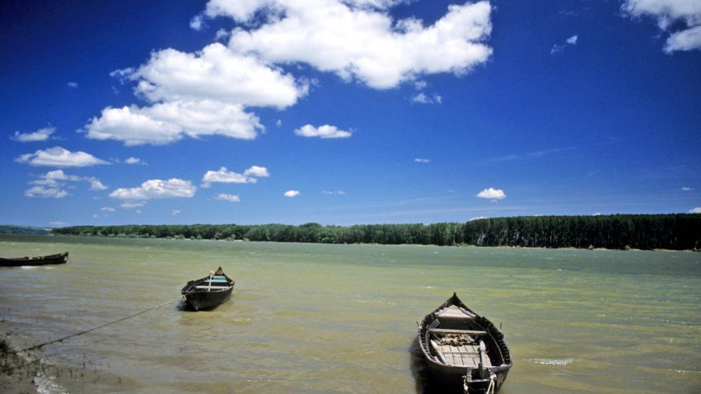 small boats on the water with clouds above 