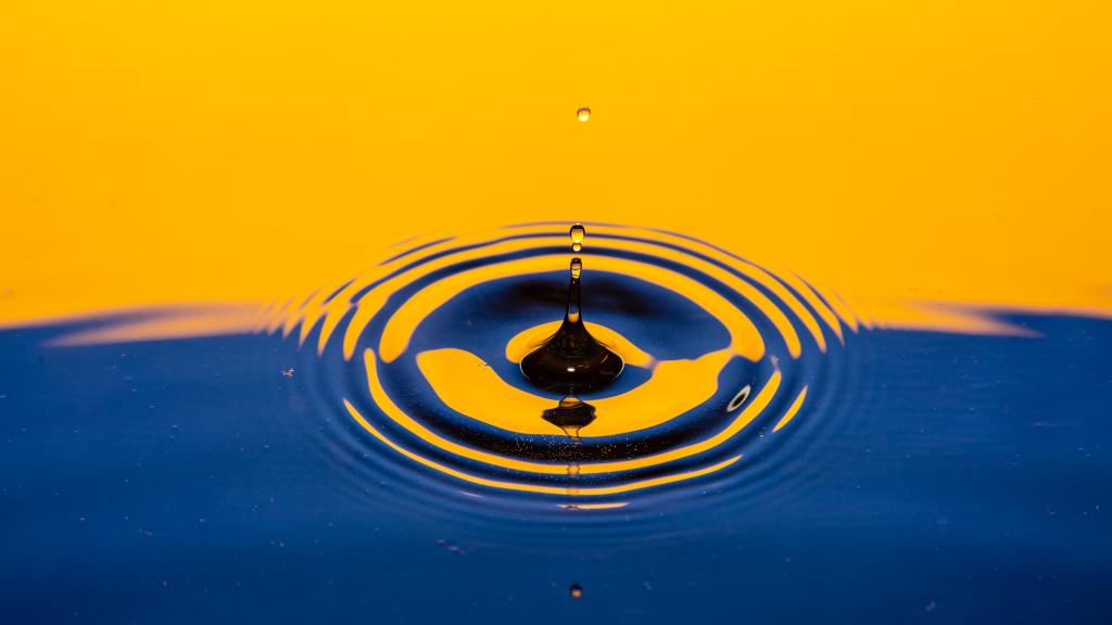falling drop of water on a Ukraine flag background, blue and yellow