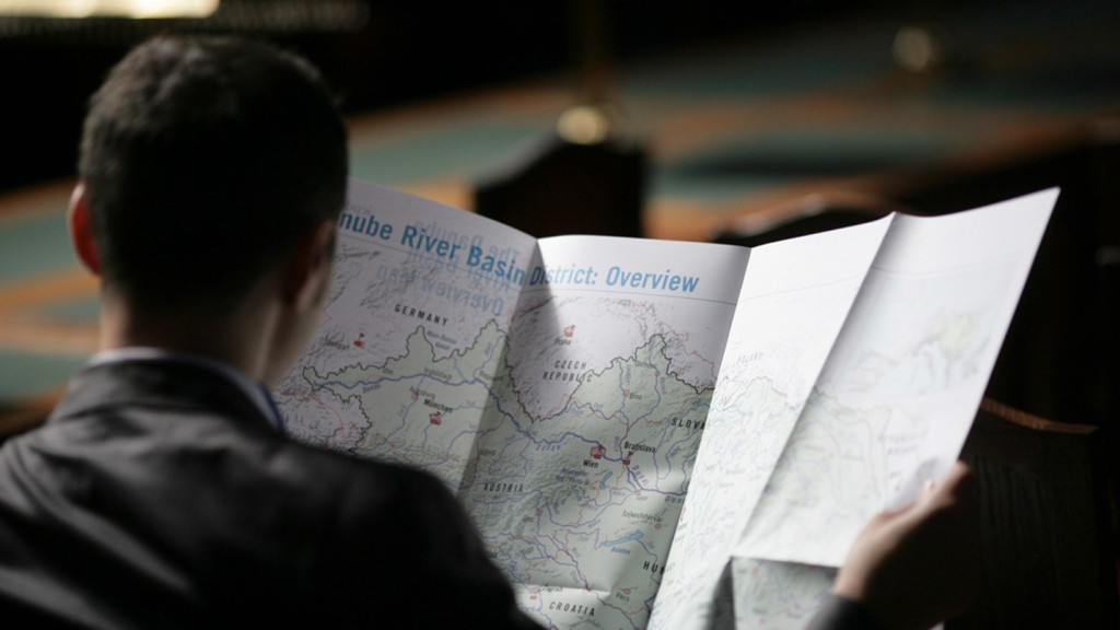 © ICPDR A man from the back reading from a map open in fron of him