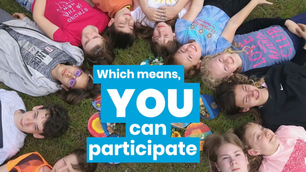 Image of teens laying on the grass, with a text that says: 'which means you can particpate'