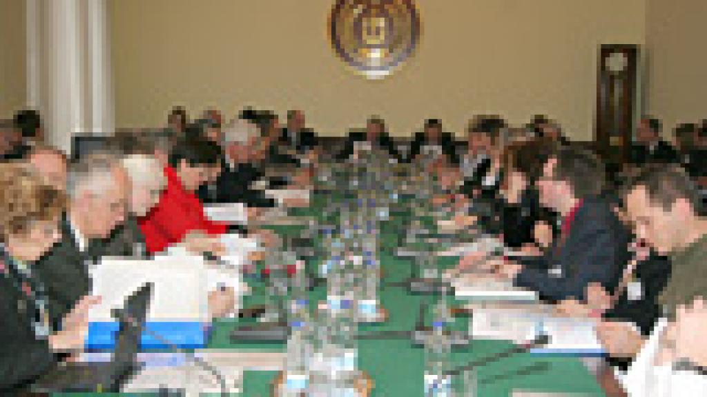 a group of people sitting at a table having a meeting