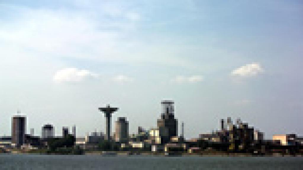 a large body of water with a city in the background