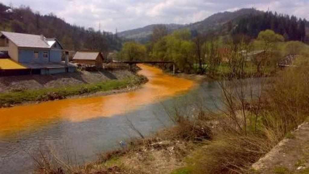 Polluted river running along town