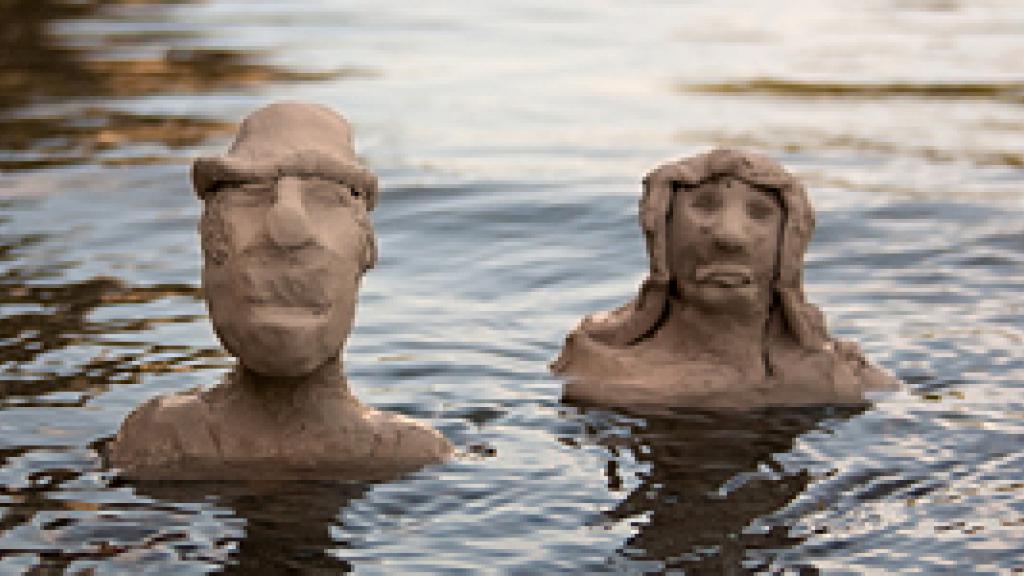 Two clay busts in water