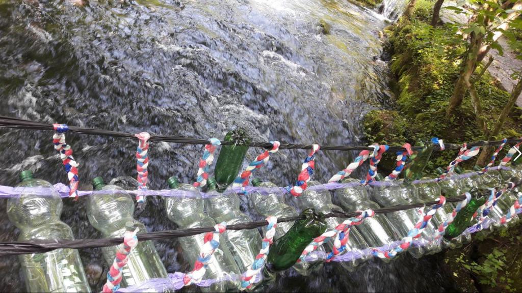 Artwork piece: Small river bridge made out of plastic bottles.