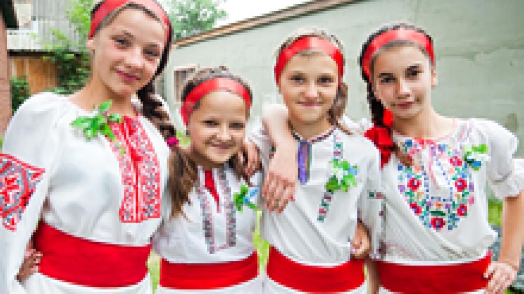 Young girls in traditional clothing posing for picture
