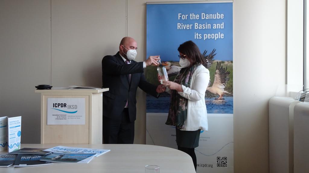 A Montenegrin and Moldovan representative exchange bottle of Danube water