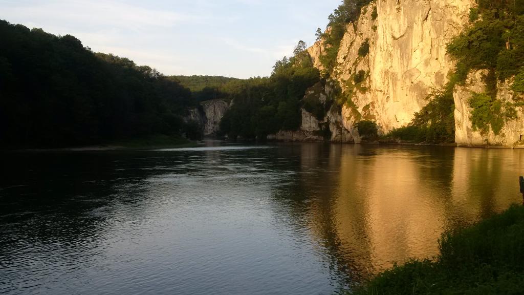 A body of water surrounded by forest cliffs