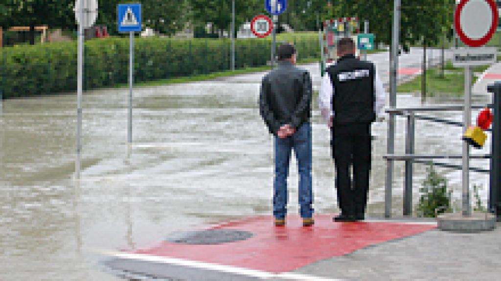 people walking down a flooded street