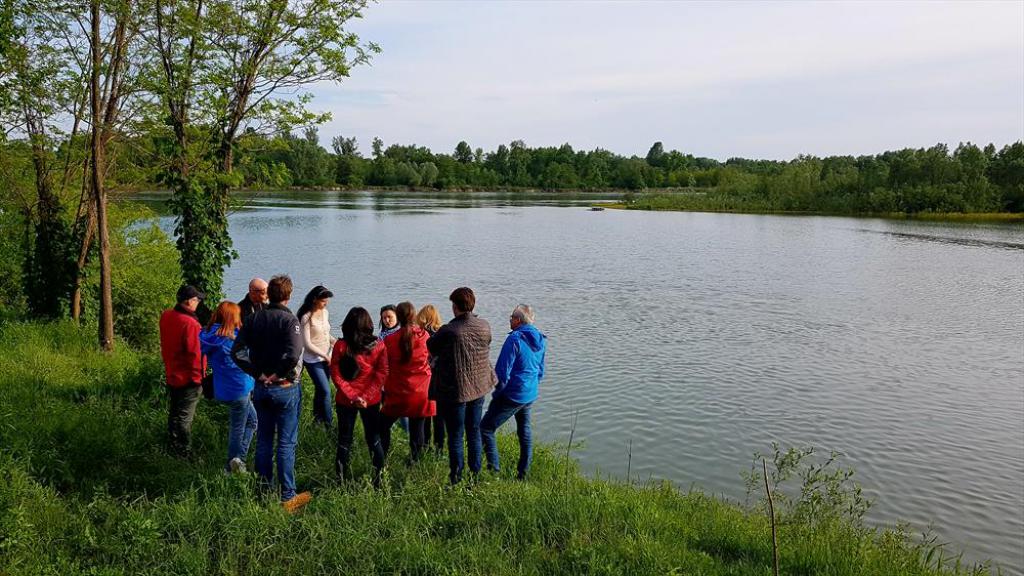 a group of people standing next to a body of water