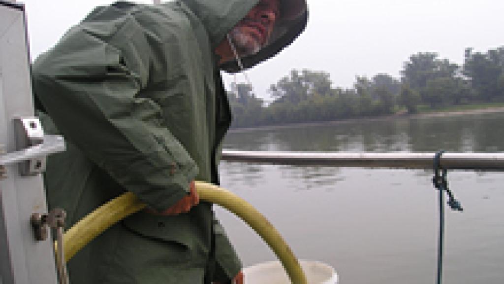 a man standing next to a body of water