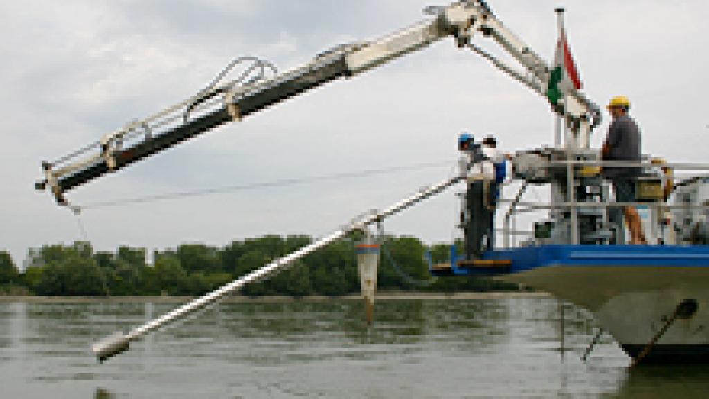 a small boat taking samples in a river