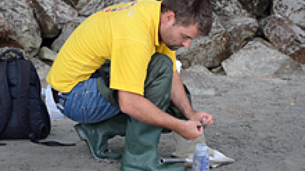 Man gathering sample on riverbank for JDS3