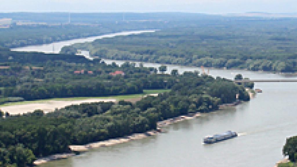 a large body of water with a mountain in the background