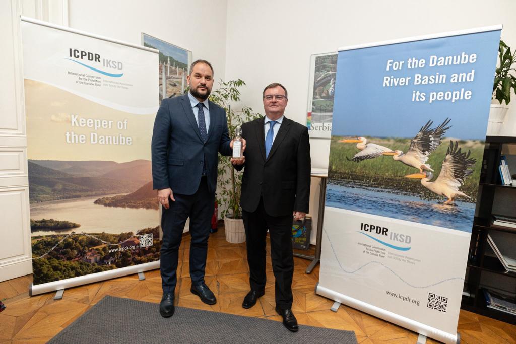 ©ICPDR two men standing in front of two signs