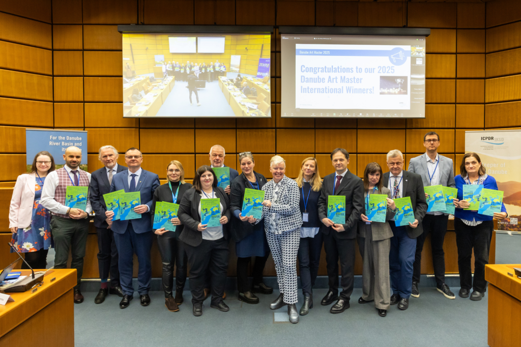 Group of people stand and hold Danube Art Master 2025 certificates. 
