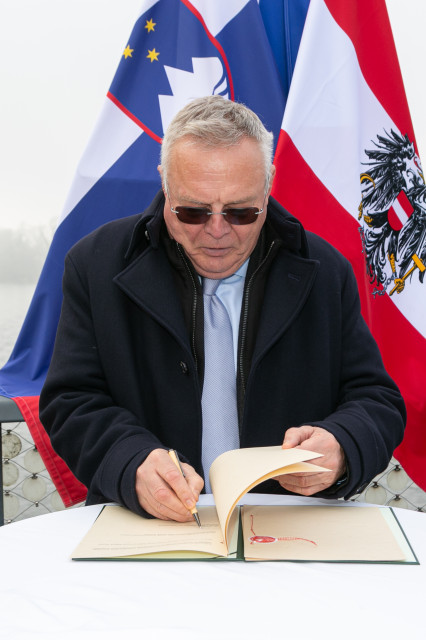 A man writing in a book 