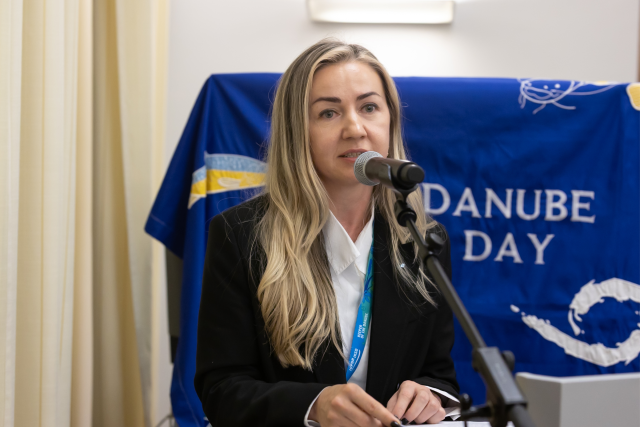 Woman speaks into microphone. 