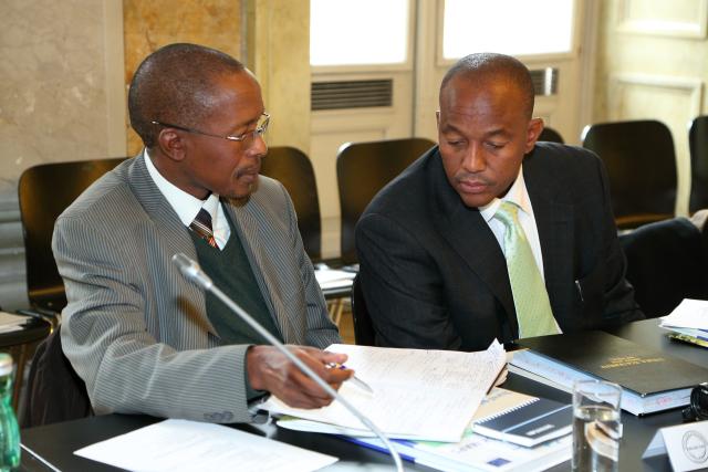 Two attendees at 15th Ordinary Meeting discussing