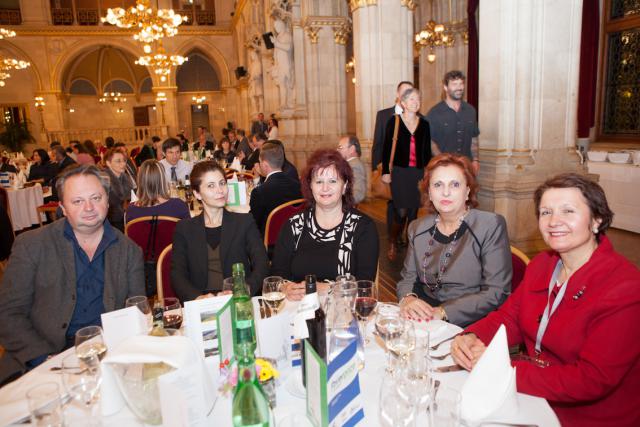 a group of people sitting at a table with wine glasses