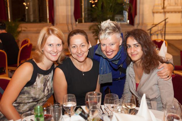 a group of people sitting at a table with wine glasses