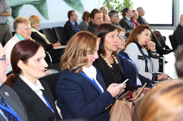 a group of people sitting and standing in front of a crowd