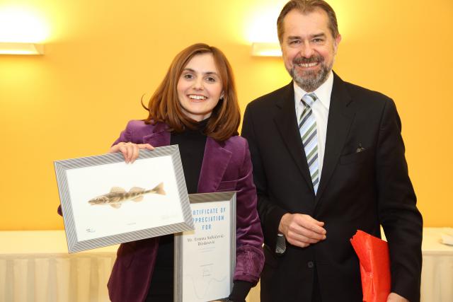 a man wearing a suit and tie standing next to a woman