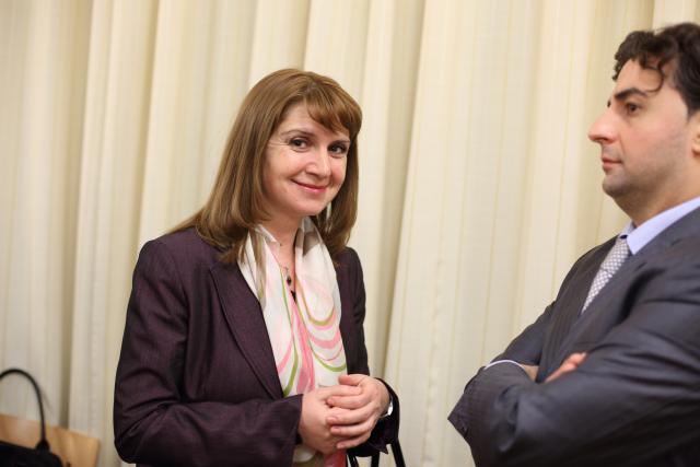 a man and a woman standing in front of a curtain