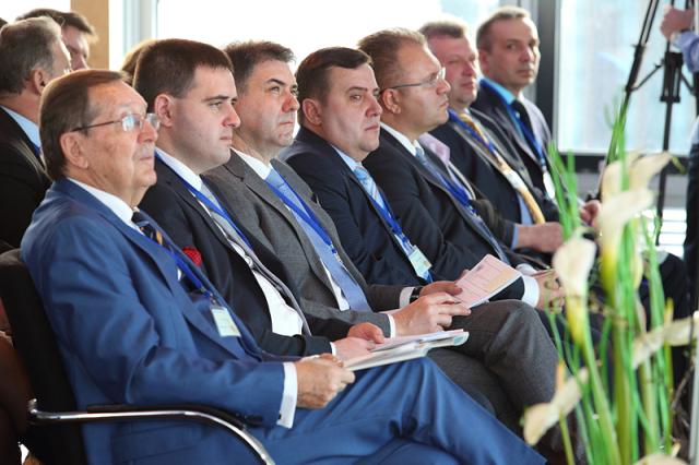 a group of people sitting in a suit and tie