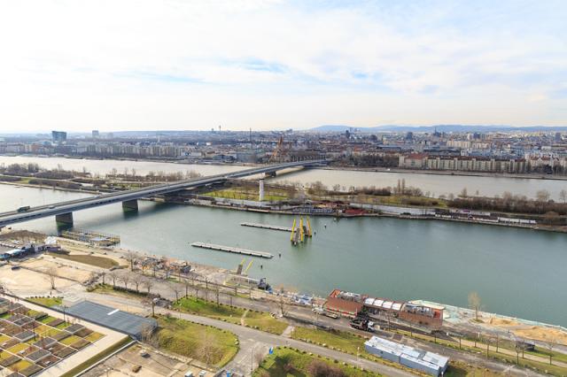 a large body of water with a city in the background