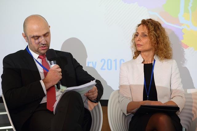 a man and a woman sitting in a suit and tie