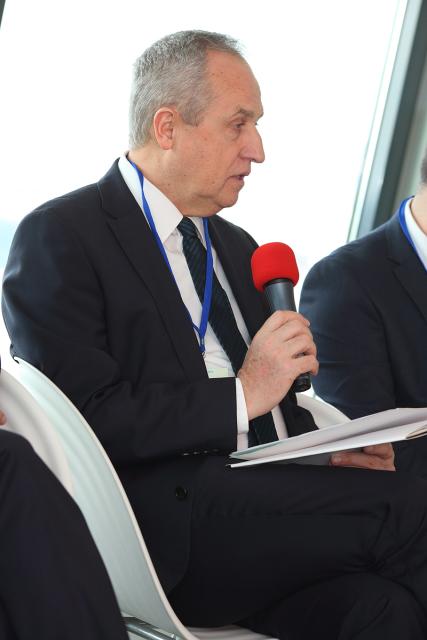 a man wearing a suit and tie talking on a cell phone