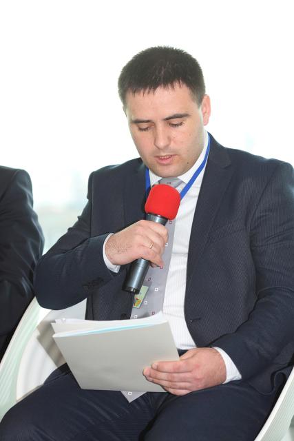 a man wearing a suit and tie reading a book