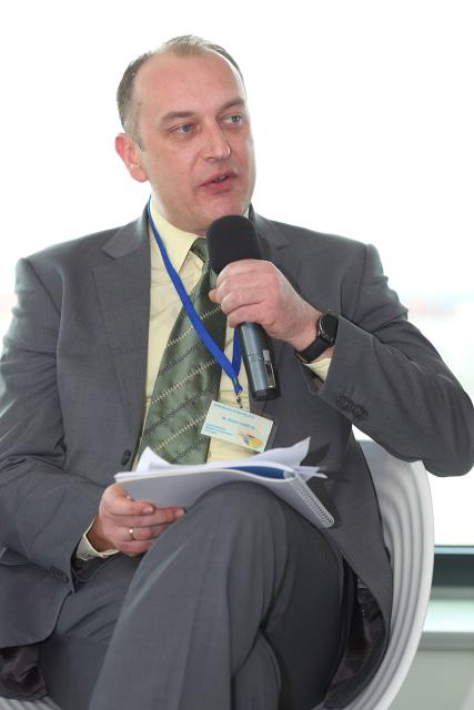 a man wearing a suit and tie reading a book