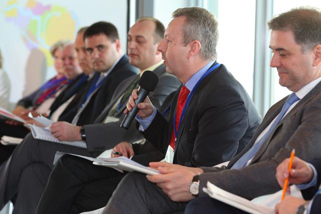 a group of people sitting in a suit and tie