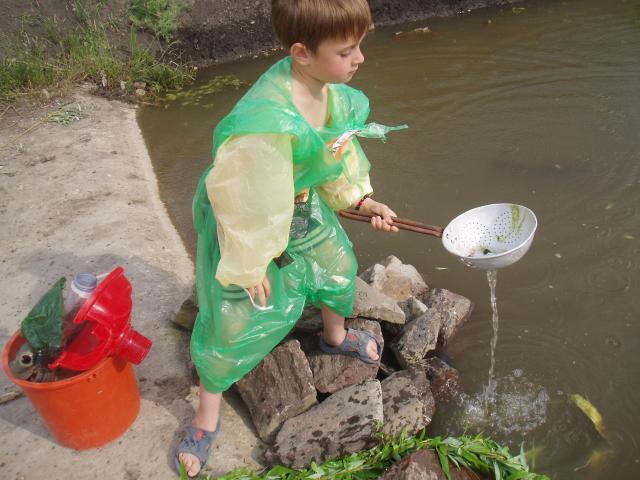 a little boy that is standing in the water