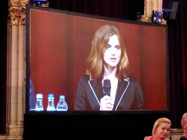 a person standing in front of a television